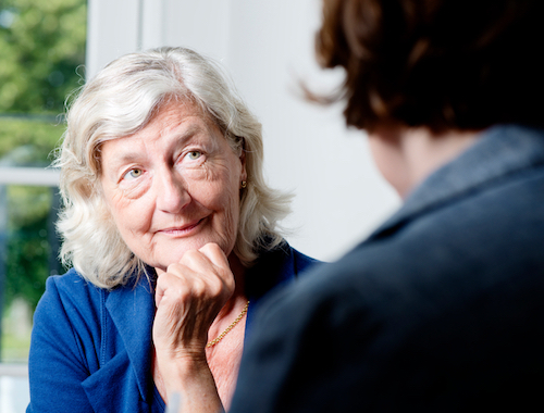 A counselor speaking with an older woman