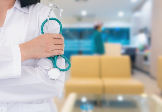 a medical professional holding a medical tool in a medical office